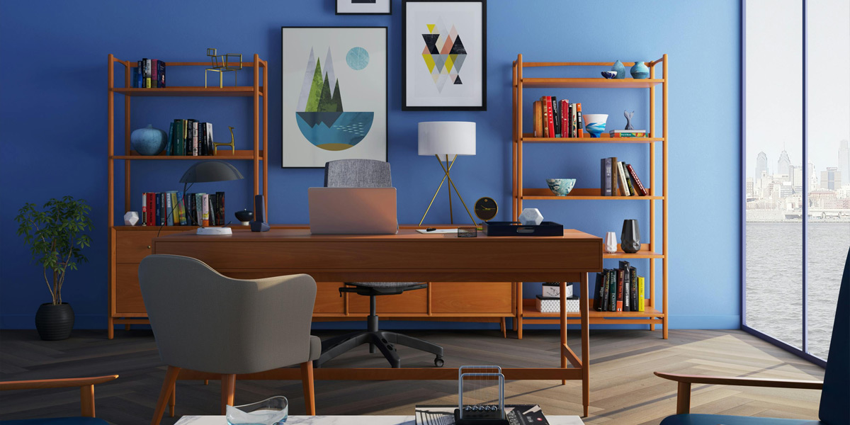 Home office interior featuring an office table placed between two opposite chairs, with a custom bookshelf against a blue-colored wall