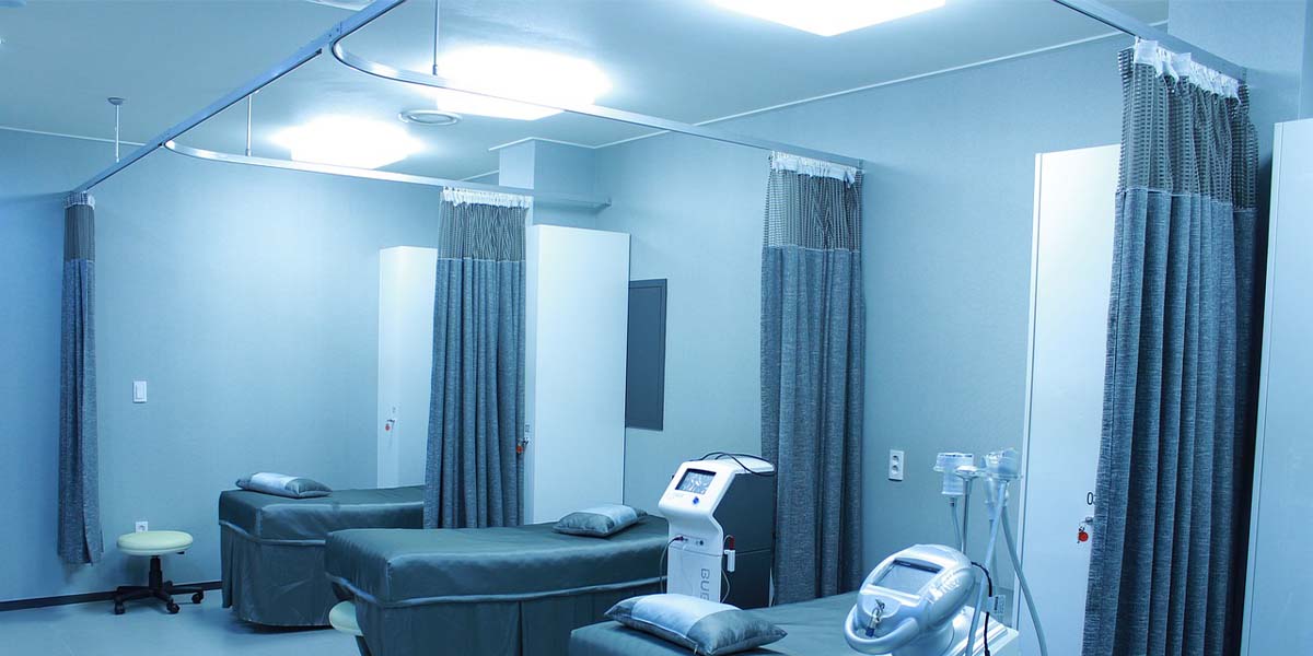 Three high class bedding divided by gray curtains in a Hospital
