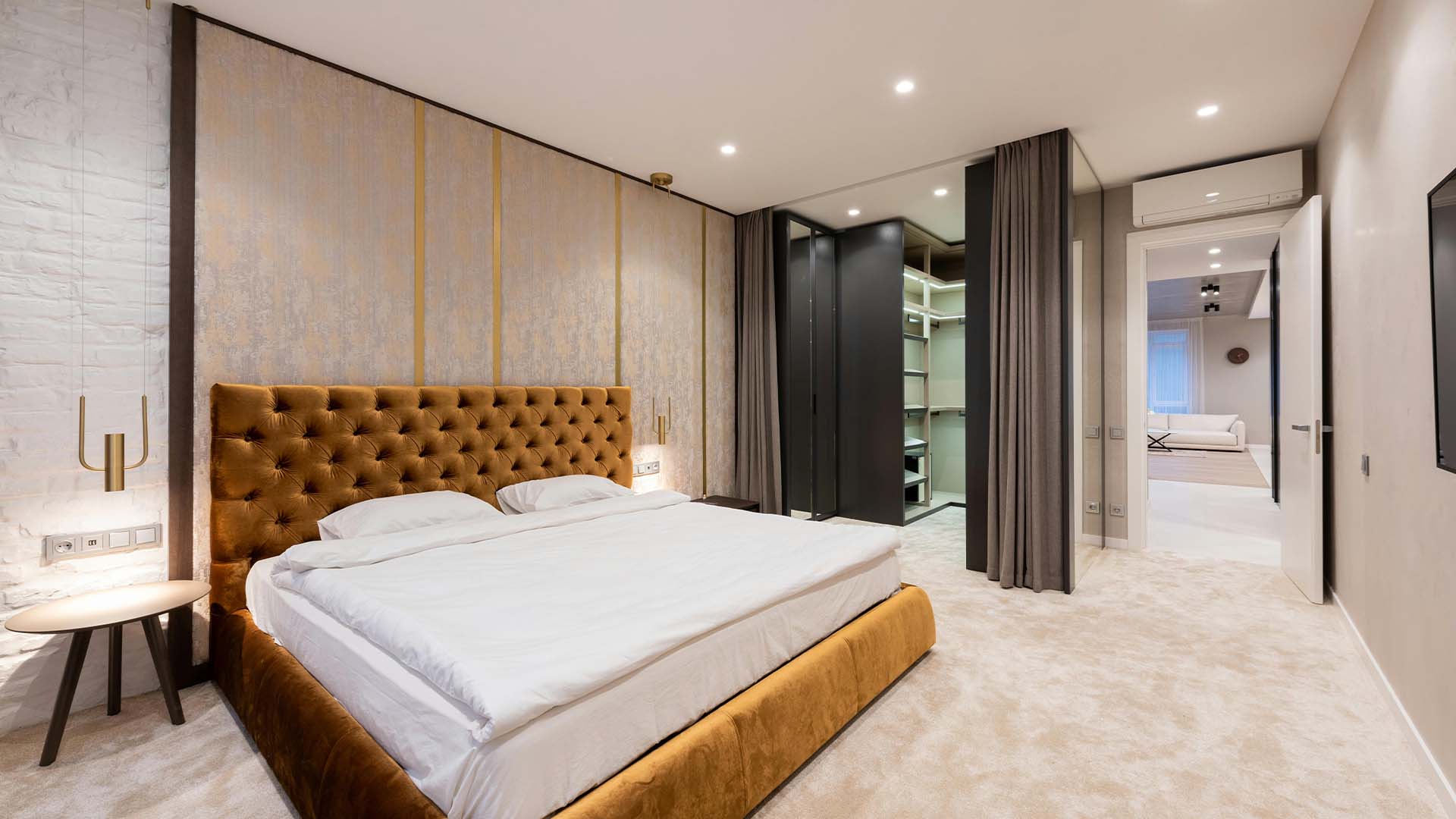 Modern bedroom interior with a custom-made closet beside the bed